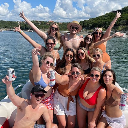 People enjoying time on a boat on the lake Austin